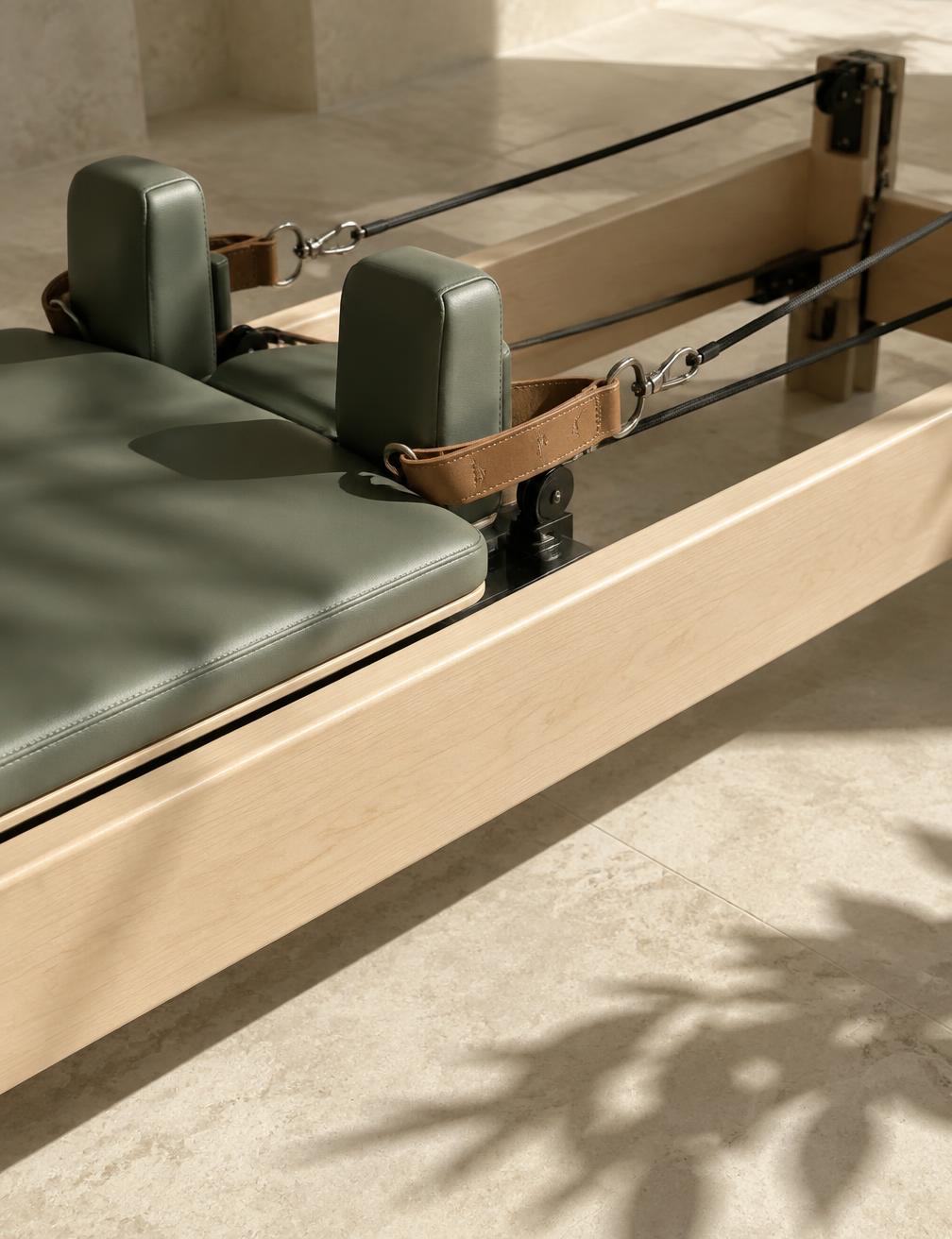 Close detail of a premium reformer carriage in warm daylight
